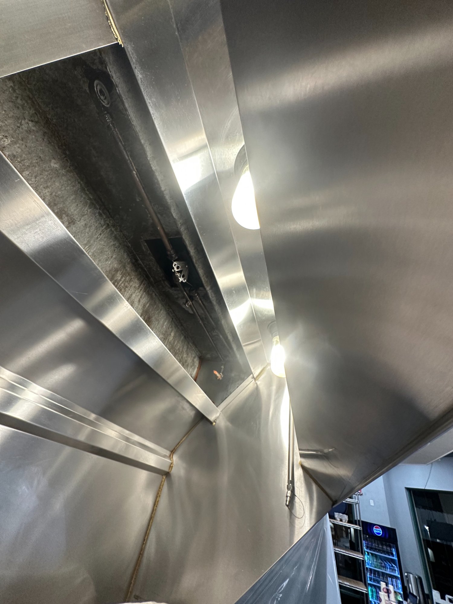 Clean commercial kitchen exhaust hood after professional restaurant hood cleaning service in San Diego